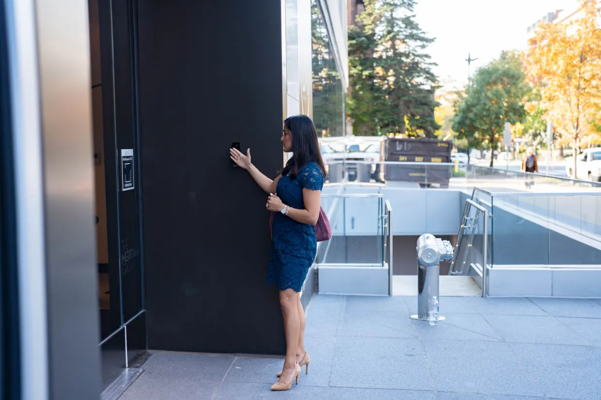Access Control - woman entering a building with access control